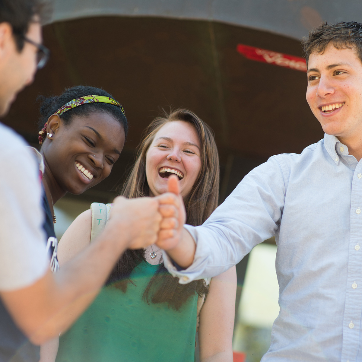 Students fist bumping and smiling