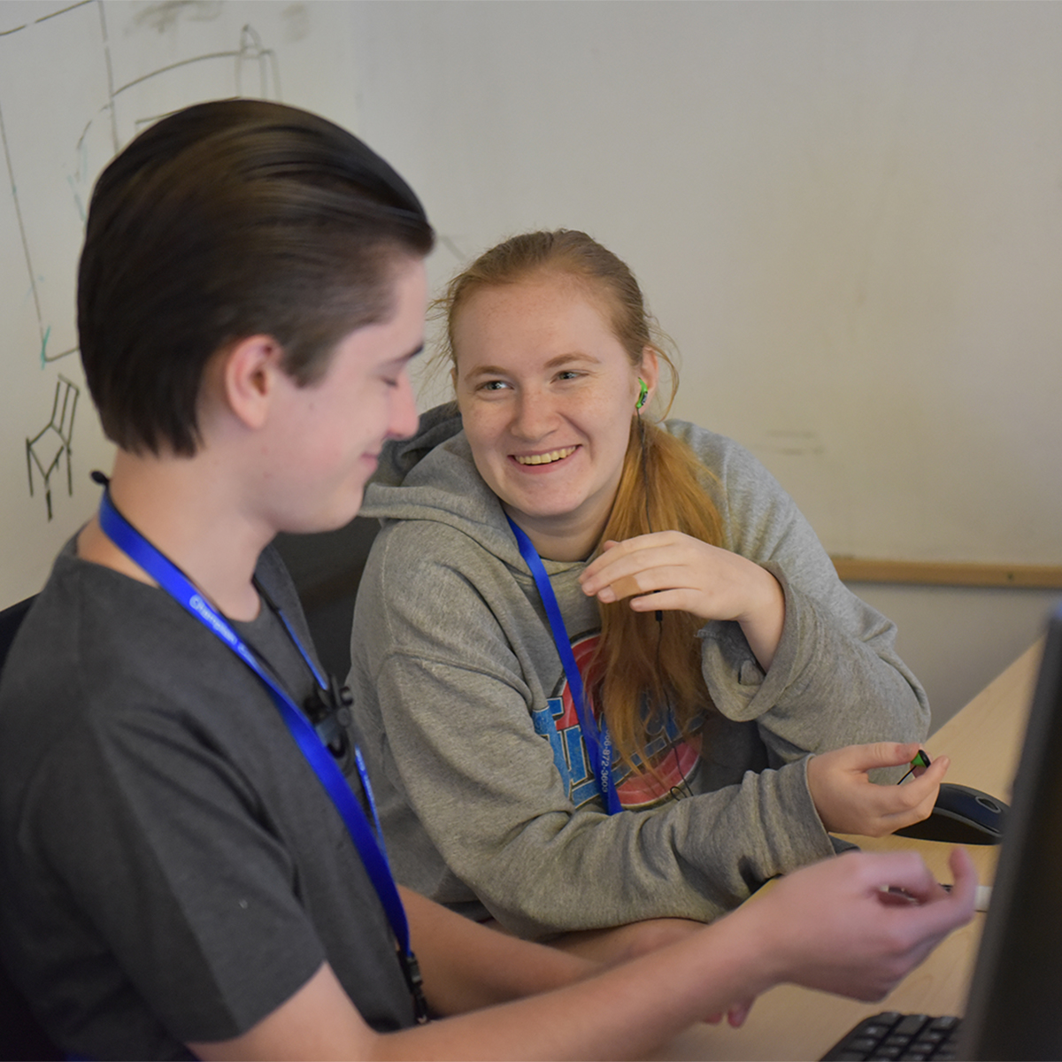 Students laughing and working on a computer project