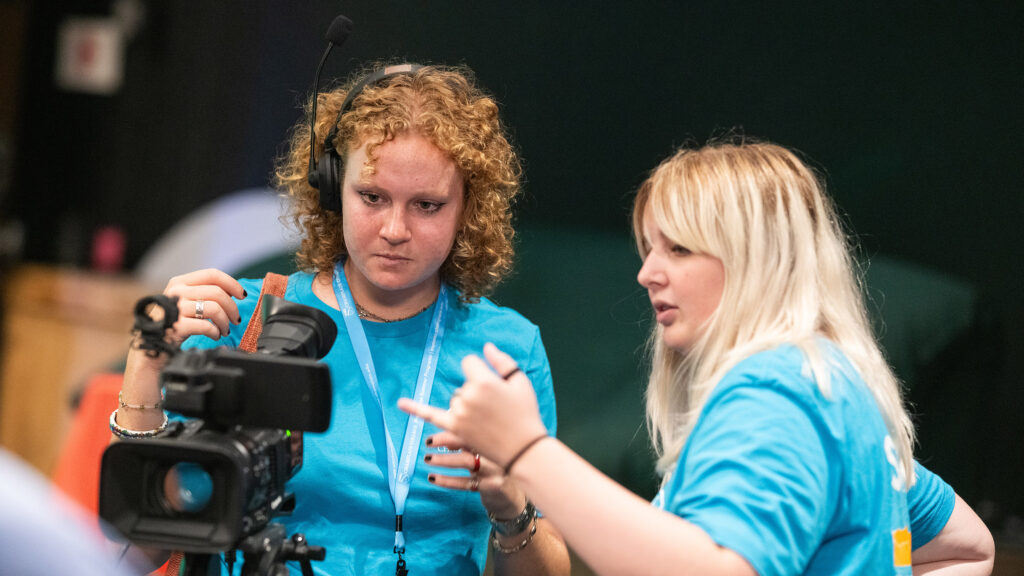 pre-college students work with a video camera in the studio