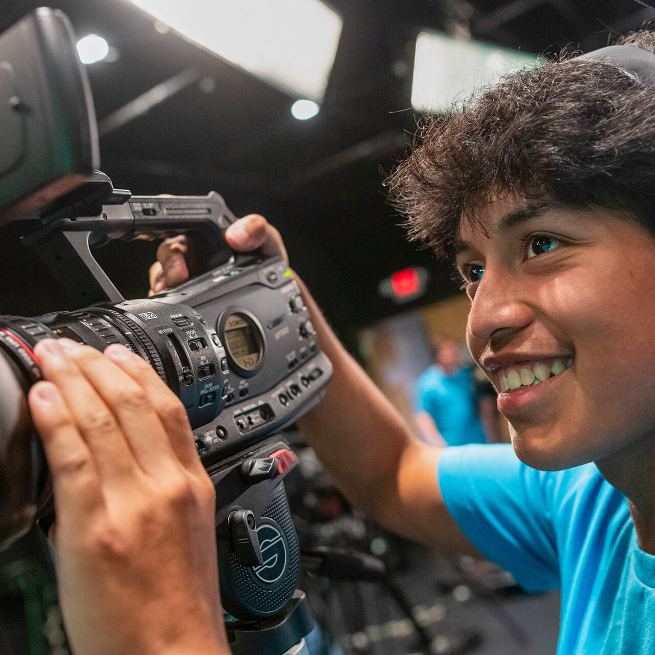 pre-college student work with a video camera in the studio