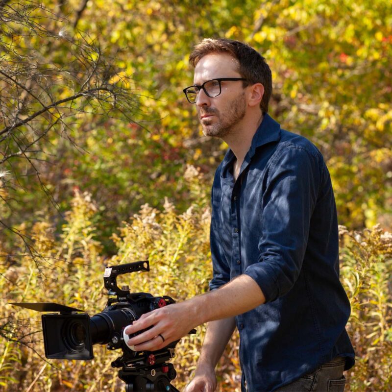 Man with a film camera outside